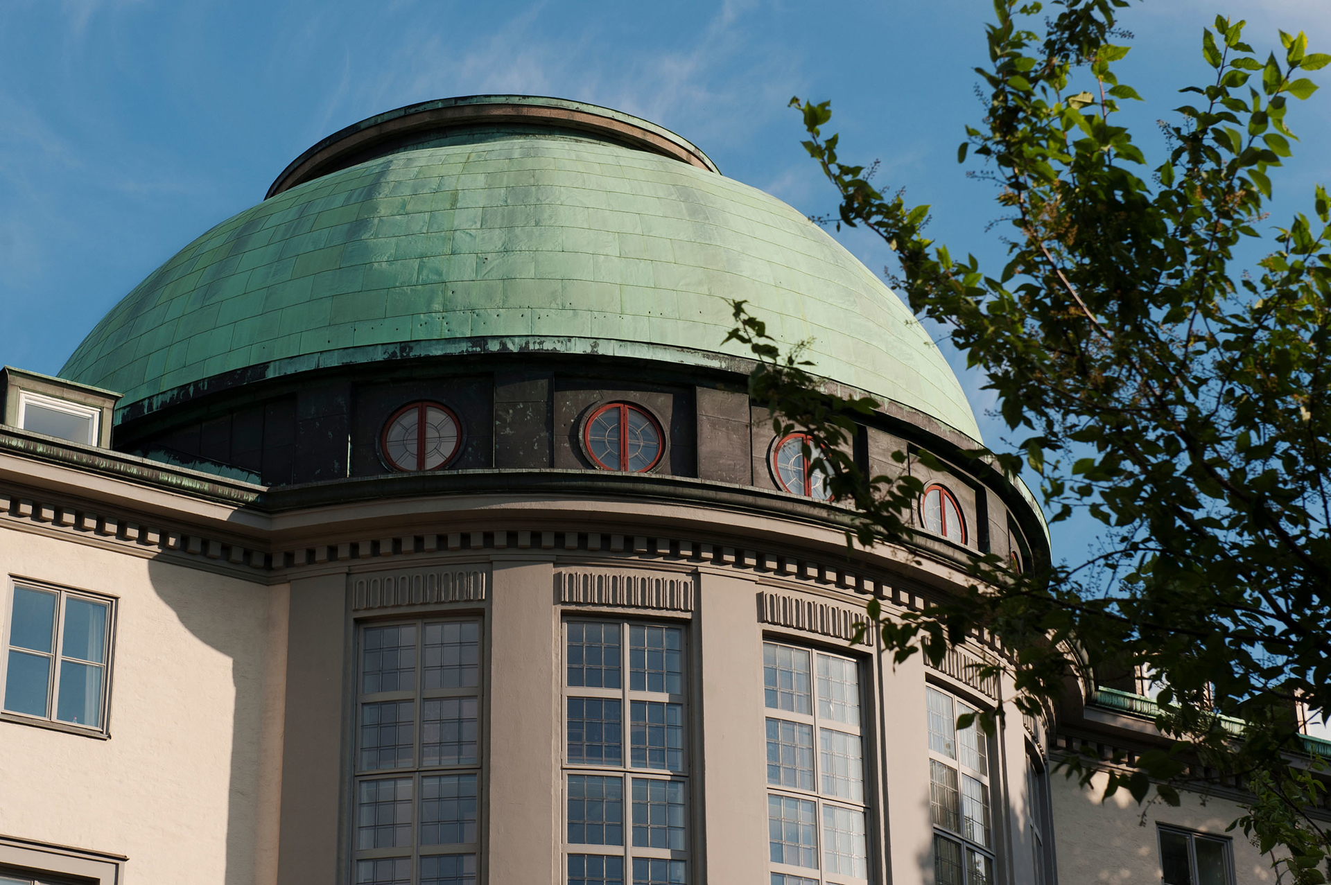 The copper-green dome of the Stockholm School of Economics main building
