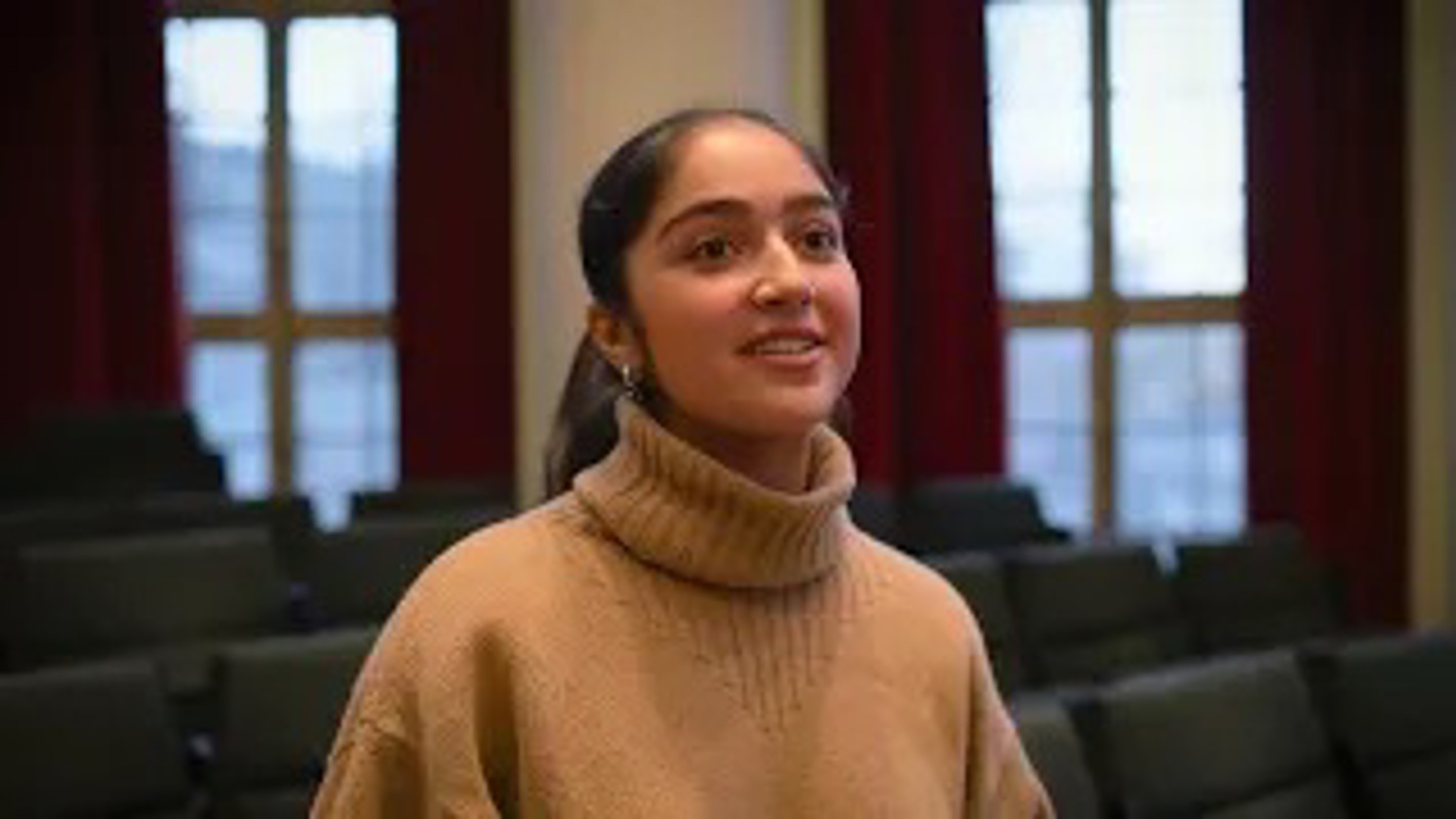Student speaking in a lecture hall for the Global Challenges series