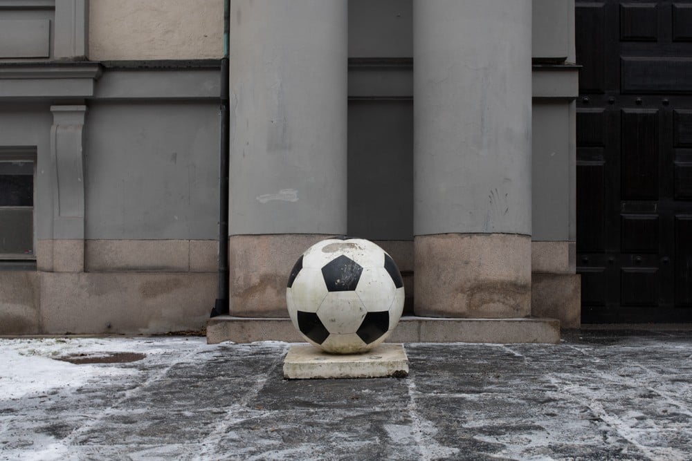 A football in front of an oak door at the Stockholm School of Economics