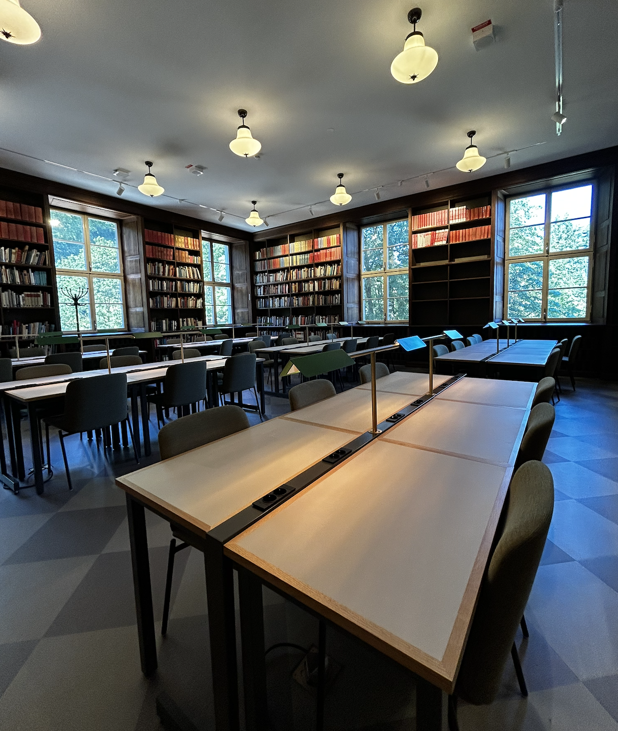 The Bonnier room with wooden bookshelves and study desks